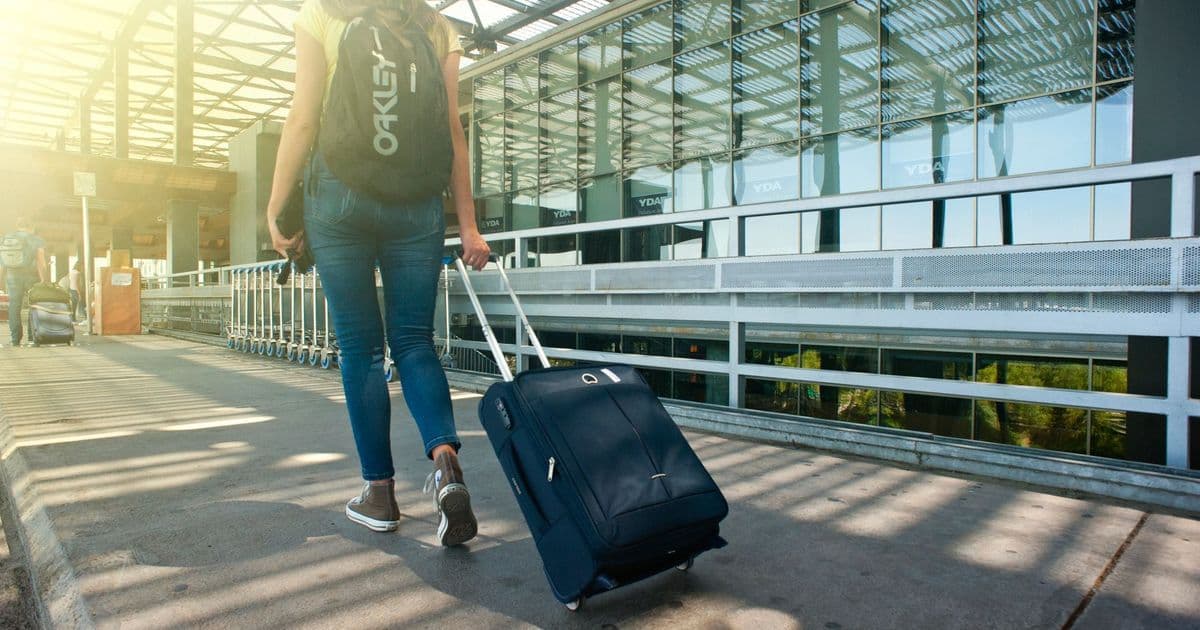 Busy airport terminal departure hall with travellers